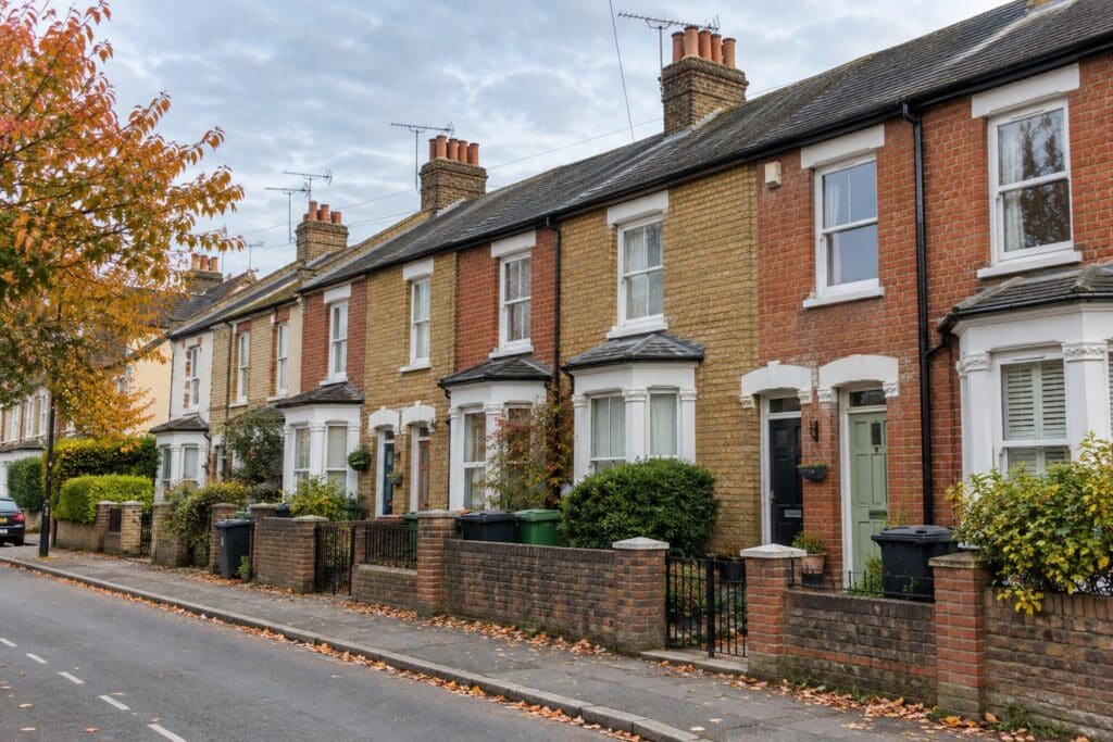 Traditional British brick terraced houses and front gardens on a residential street, for Ashford HMO controls news