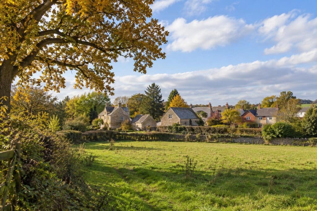 Sutton Benger appeal illustrated by a Wiltshire village-edge paddock, traditional stone farm buildings and autumn foliage